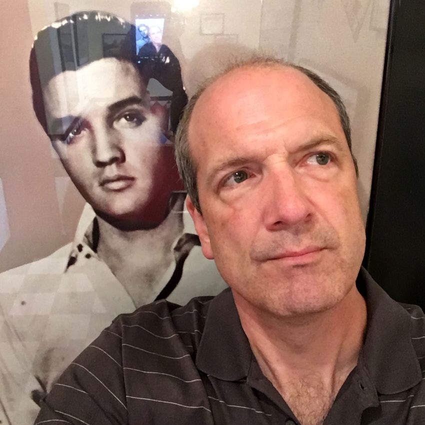Alan with an Elvis picture behind him